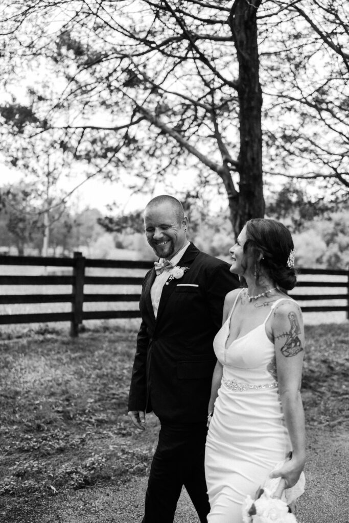Bride and groom enjoying their time together during their walk, laughing together and soaking up the moments- Quinn Photography LLC