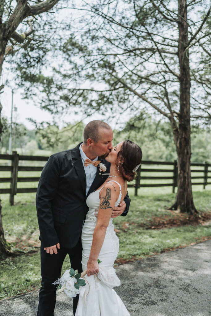 Bride and groom sharing a romantic gentle kiss during their walk- Quinn Photography LLC
