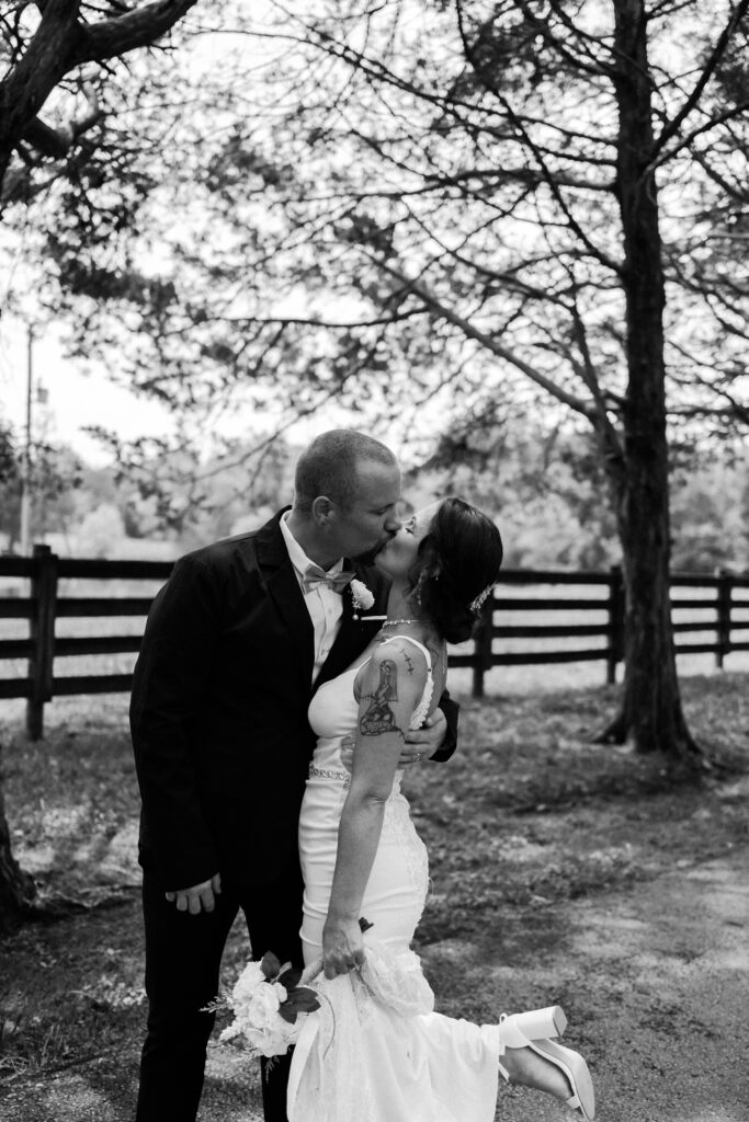 Bride and groom sharing a kiss in black and white- Quinn Photography LLC