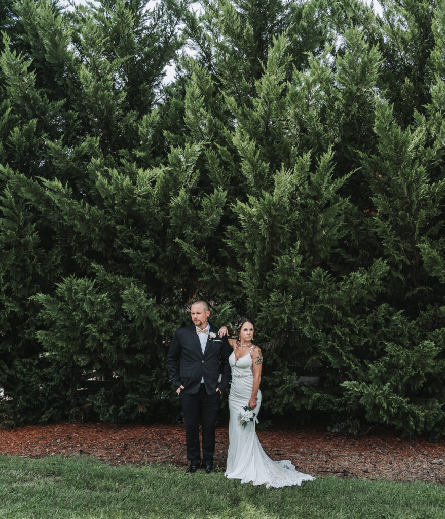 Bride and groom posing for their bride and groom portraits- Quinn Photography LLC