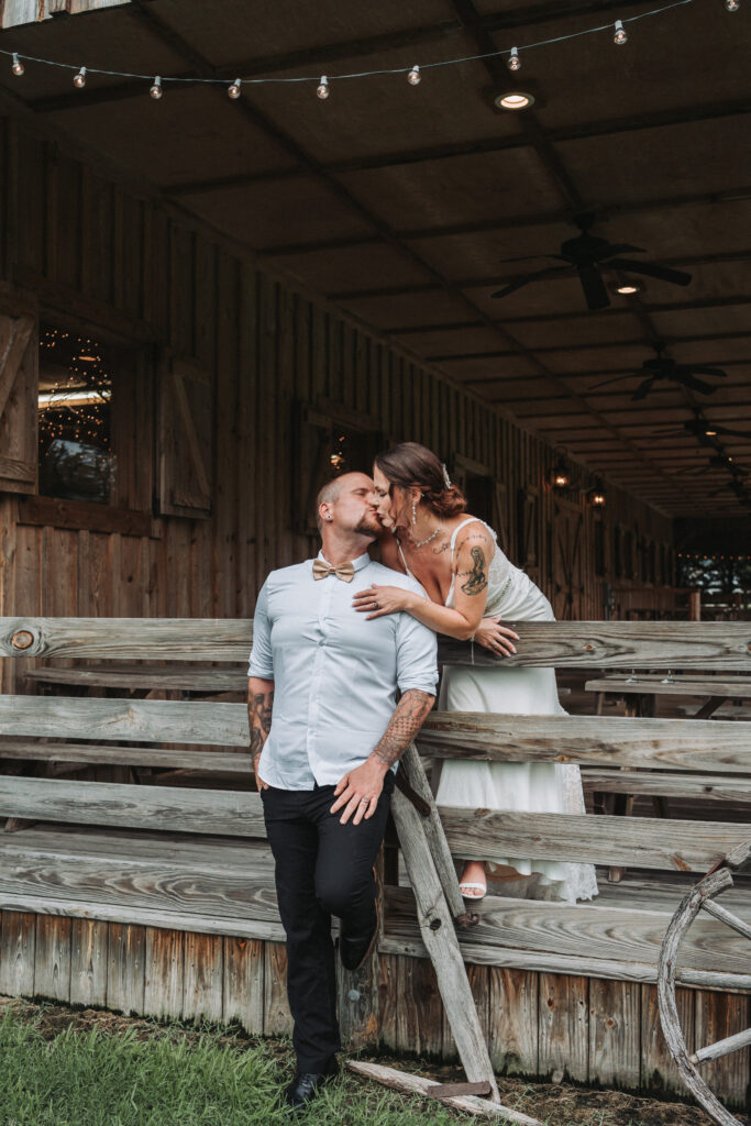Bride and groom sharing a kiss during bridal portraits at Gentry Farm- Quinn Photography LLC