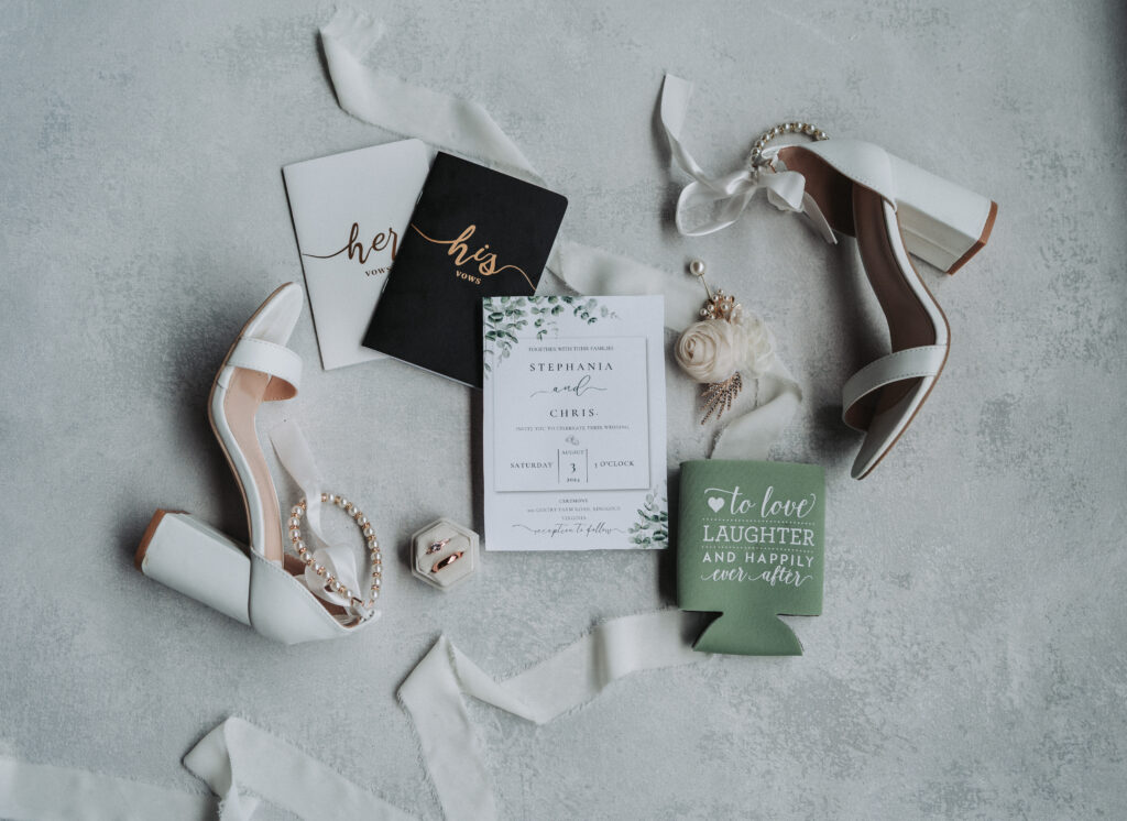 Detail flatlay during wedding styled shoot, wedding invitations sitting in the middle to grab focus of the viewer, photo taken at the Gentry Farm in Danville Virginia by wedding photographer Quinn Photography LLC