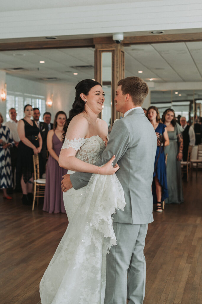 Bride and groom sharing a joyful first dance at Lesner Inn