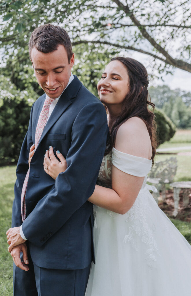 Bride smiles at groom during outdoor wedding portraits at Due Sorelle
